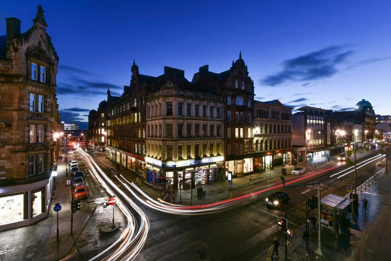 a busy city street at night with traffic and buildings at Fraser Suites Glasgow in Glasgow