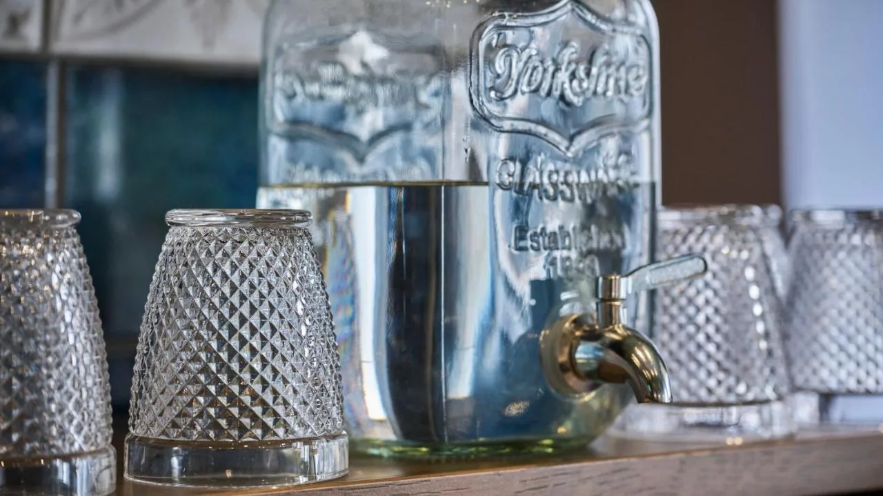 a row of glass jars on a shelf at Fraser Suites Glasgow in Glasgow